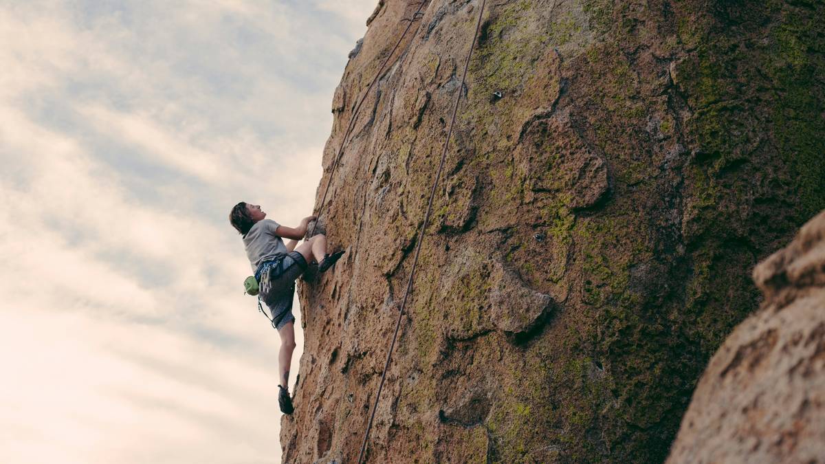 Climber demonstrating Active Cam Placement Guides in a granite crack